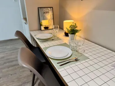 a table with chairs and plates and glasses on it at Athens Platonos Appartment in Athens