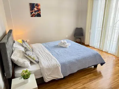 a bedroom with a bed with two towels on it at Athens Platonos Appartment in Athens