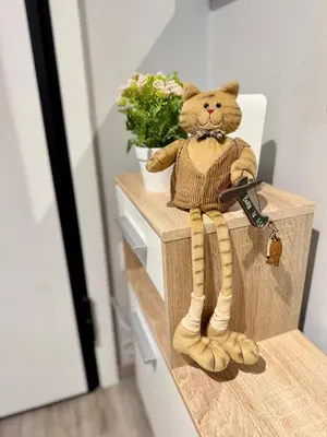 a teddy bear sitting on a counter with a key at Athens Platonos Appartment in Athens