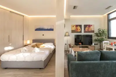 a bedroom with a bed and a living room at Luxury Haven in the most ideal area of Athens in Athens