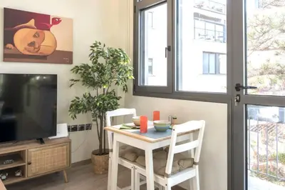 a living room with a table and a tv at Luxury Haven in the most ideal area of Athens in Athens