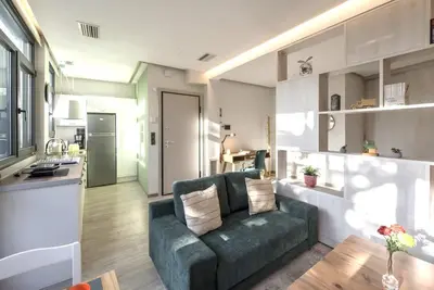 a living room with a couch and a kitchen at Luxury Haven in the most ideal area of Athens in Athens