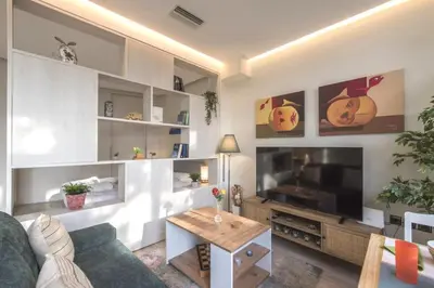 a living room with a couch and a tv and a table at Luxury Haven in the most ideal area of Athens in Athens