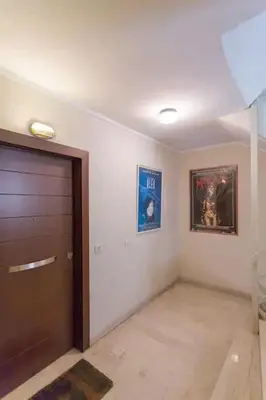a room with a door and two pictures on the wall at Stylish Apartment in the Heart of Nea Smyrni in Athens