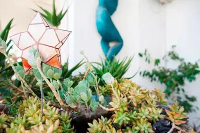 a succulent plant with a stained glass flower on it at Stylish Apartment in the Heart of Nea Smyrni in Athens