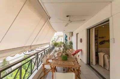 a balcony with a table and chairs on it at Stylish Apartment in the Heart of Nea Smyrni in Athens