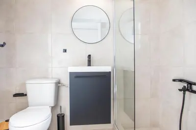 a bathroom with a toilet and a mirror at Lucas apartment 3 in Athens