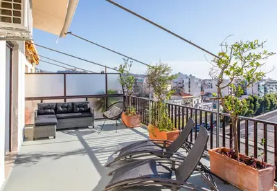 a balcony with chairs and a couch on a building at Lucas apartment 3 in Athens