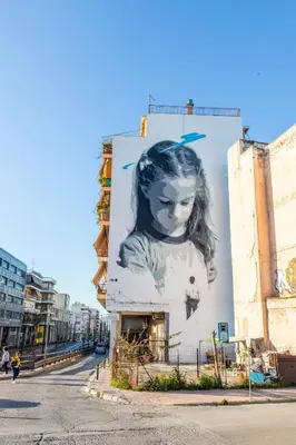 a large mural of a girl on the side of a building at Lucas apartment 3 in Athens