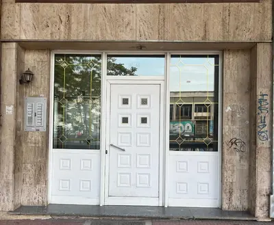 a pair of white doors on a building at Lucas apartment 3 in Athens