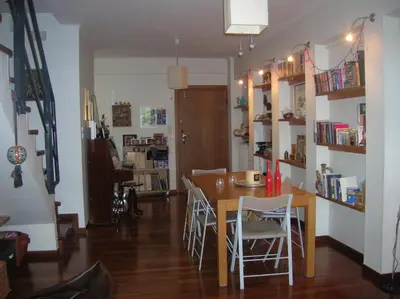 a dining room with a table and chairs at Cozy maisonette in Athinaiki Riviera of Palaio Faliro in Athens