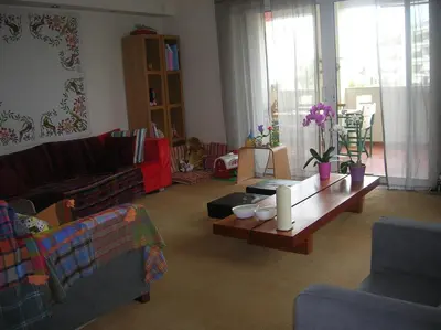 a living room with a couch and a coffee table at Cozy maisonette in Athinaiki Riviera of Palaio Faliro in Athens
