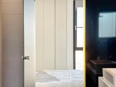 a door to a bedroom with a bed and a window at Luxury Loft with Private Jacuzzi in Athens