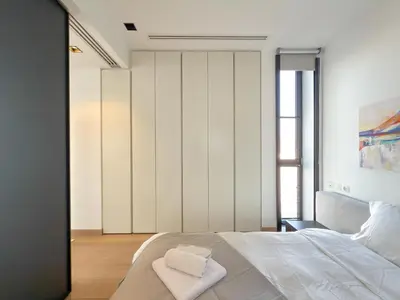 a bedroom with a bed with two towels on it at Luxury Loft with Private Jacuzzi in Athens
