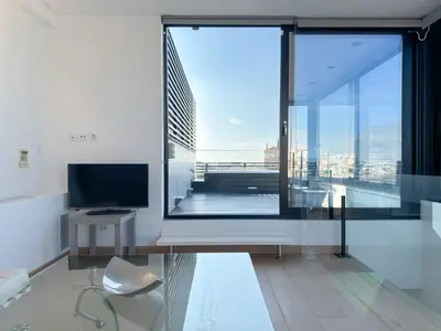 a living room with a large window and a television at Luxury Loft with Private Jacuzzi in Athens