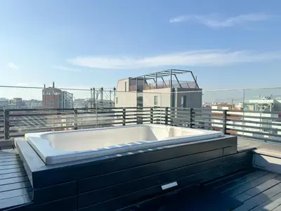 a bath tub sitting on top of a roof at Luxury Loft with Private Jacuzzi in Athens
