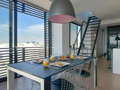 a dining room with a table with food and orange juice at Luxury Loft with Private Jacuzzi in Athens