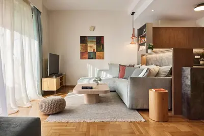 a living room with a couch and a table at Acropolis Museum Central Suite in Athens