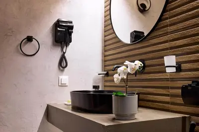 a bathroom with a sink and a mirror at Acropolis Museum Central Suite in Athens