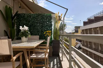 a patio with a table and chairs on a balcony at Acropolis Museum Central Suite in Athens
