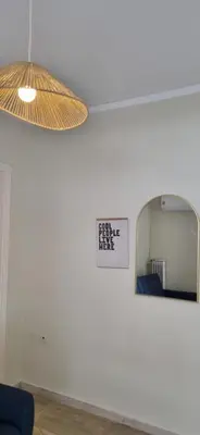 a room with a mirror and a sign on the wall at Bohemian Apartment Near The Museum And Exarchia in Athens