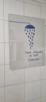 a sign on a wall with an umbrella on it at Bohemian Apartment Near The Museum And Exarchia in Athens