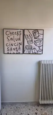 three drawings on a wall with a radiator at Bohemian Apartment Near The Museum And Exarchia in Athens