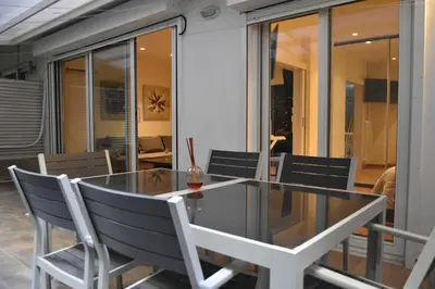 a glass table and chairs on a balcony at Peaceful Retreat in Kolonaki in Athens