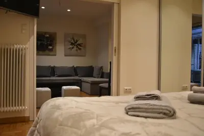 a bedroom with a bed and a couch at Peaceful Retreat in Kolonaki in Athens