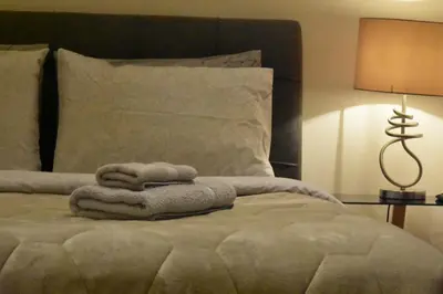 a bed with a pile of towels on it at Peaceful Retreat in Kolonaki in Athens