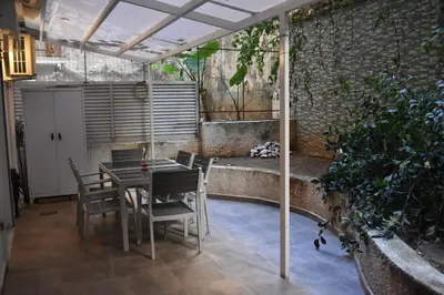 a patio with a table and chairs under a pergola at Peaceful Retreat in Kolonaki in Athens