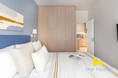 a bedroom with a bed with a book on it at Koukaki Elegance - Athenian Retreat near Acropolis in Athens