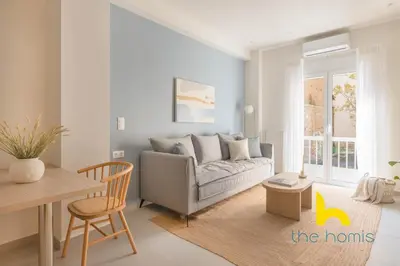 a living room with a couch and a table at Koukaki Elegance - Athenian Retreat near Acropolis in Athens