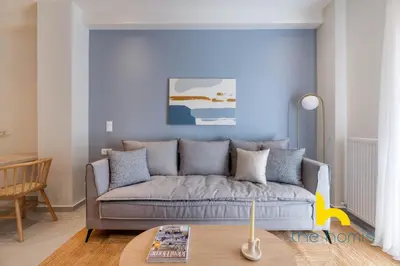 a living room with a couch and a table at Koukaki Elegance - Athenian Retreat near Acropolis in Athens