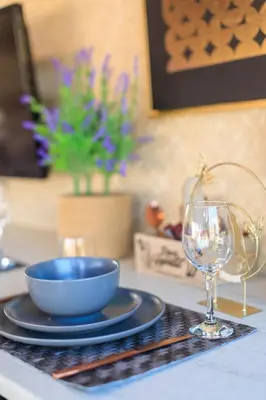 a table with a bowl and a plate and a glass at AIOLOS Rooftop suite centre GLYFADA in Athens