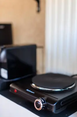 a black cell phone sitting on top of a counter at AIOLOS Rooftop suite centre GLYFADA in Athens