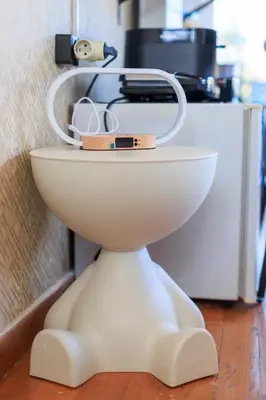 a white toilet with a holder on top of it at AIOLOS Rooftop suite centre GLYFADA in Athens
