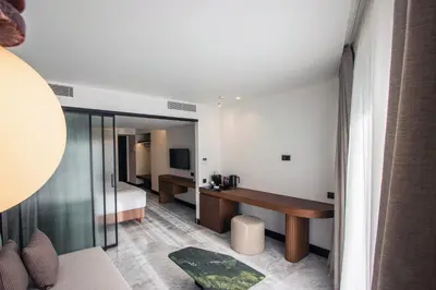 a bedroom with a bed and a desk in a room at L'Avventura Suites in Athens