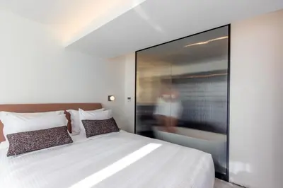 a bedroom with a large white bed with pillows at L'Avventura Suites in Athens