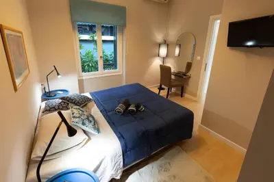 a bedroom with a blue bed with two shoes on it at Boutique Apartment Τhe City Definition METRO 1 in Piraeus