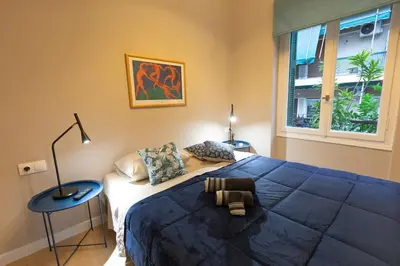 a bedroom with a large bed and a window at Boutique Apartment Τhe City Definition METRO 1 in Piraeus