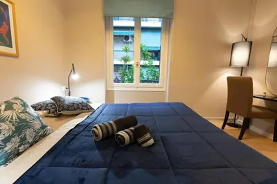 a large blue bed in a room with a window at Boutique Apartment Τhe City Definition METRO 1 in Piraeus