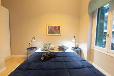 a bedroom with a large bed with two tables at Boutique Apartment Τhe City Definition METRO 1 in Piraeus