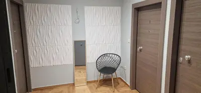 a black chair in a room with a wall at New Ventiri Suite 6, near Hilton, Athens Central , 4 family & Bussines in Athens