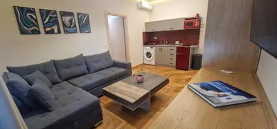 a living room with a couch and a table at New Ventiri Suite 6, near Hilton, Athens Central , 4 family & Bussines in Athens