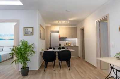 a kitchen and living room with a table and chairs at A Lux, Athens center, Syntagma! Work or Play in Athens