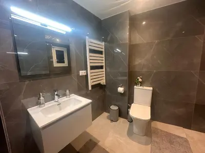 a bathroom with a sink and a toilet and a mirror at A Lux, Athens center, Syntagma! Work or Play in Athens