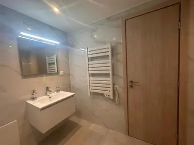 a bathroom with a sink and a mirror and a door at A Lux, Athens center, Syntagma! Work or Play in Athens