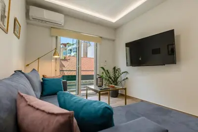 a living room with a couch and a tv at A Lux, Athens center, Syntagma! Work or Play in Athens