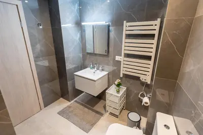 a bathroom with a sink and a toilet and a mirror at A Lux, Athens center, Syntagma! Work or Play in Athens